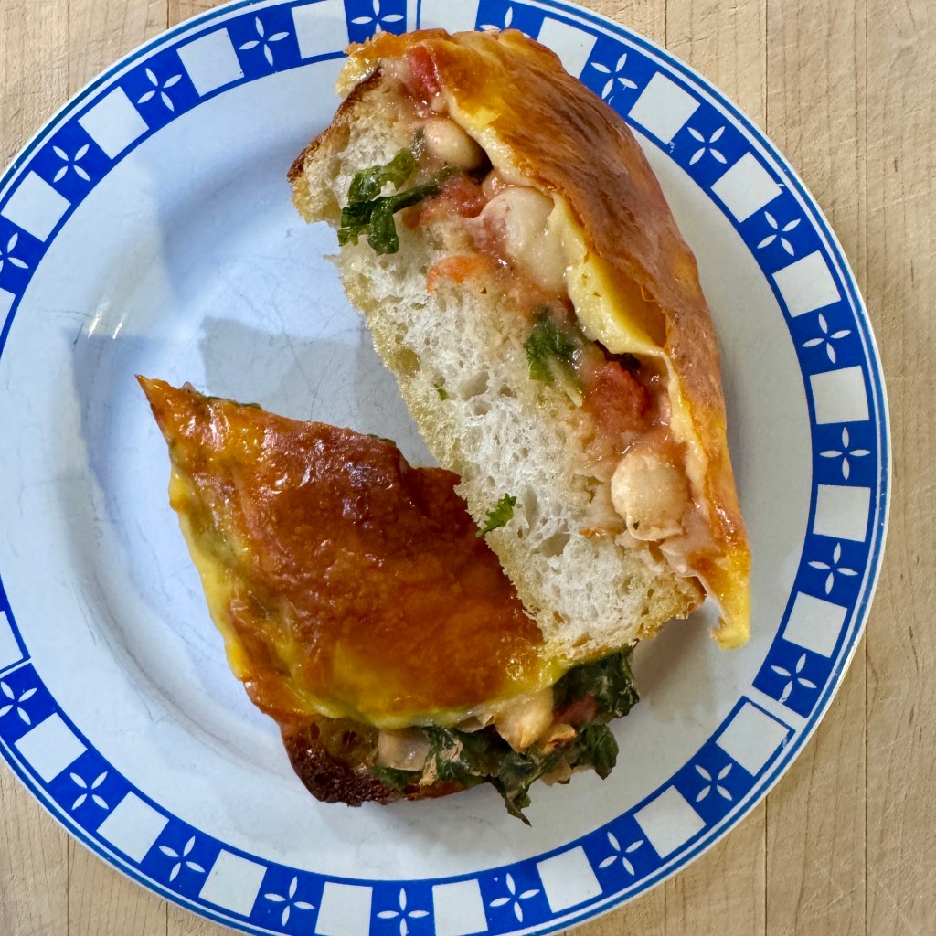 Sourdough toasts topped with stewed vegetables and cheese